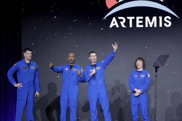 From left, Jeremy Hansen, Victor Glover, Reid Wiseman and Christina Hammock Koch, celebrate on stage as they are announced as the Artemis II crew during a NASA ceremony naming the four astronauts who will fly around the moon by the end of next year, at a ceremony held in the NASA hanger at Ellington airport Monday, April 3, 2023, in Houston. (AP Photo/Michael Wyke)