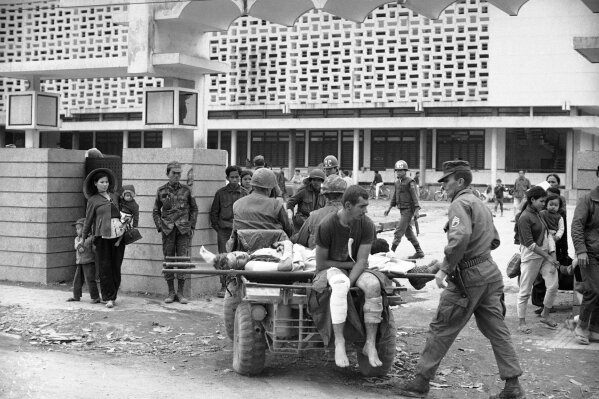 
              FILE - In this Feb. 20, 1968, file photo, a motorized cart, called a "mule," carries wounded U.S. Marines from battle areas to a first aid station near the University of Hue. U.S. and South Vietnamese Marines were struggling to crush the remnants of North Vietnamese forces in Hue's Citadel. Early on the morning of Jan. 31, 1968, as Vietnamese celebrated the Lunar New Year, or Tet as it is known locally, Communist forces launched a wave of coordinated surprise attacks across South Vietnam. The campaign, one of the largest of the Vietnam War, led to intense fighting and heavy casualties in cities and towns across the South. (AP Photo/Al Chang, File)
            