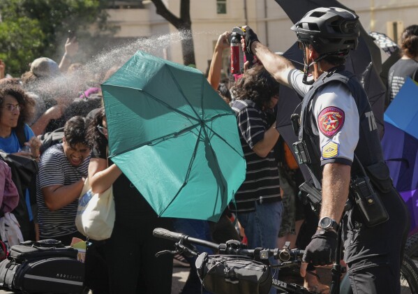 A state trooper pepper sprays protesters at a pro-Palestinian protest at the University of Texas in Austin, Texas, Monday, April 29, 2024. (Jay Janner/Austin American-Statesman via AP)
