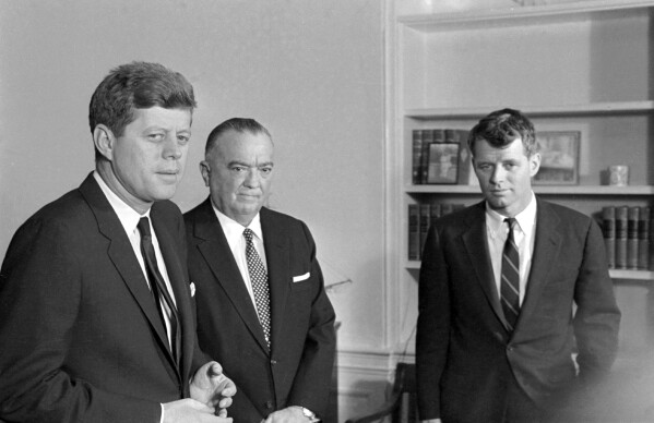 FILE - FBI Director J. Edgar Hoover speaks to President John F. Kennedy and his brother, Attorney General Robert Kennedy, during a White House conference, Feb. 23, 1961. The assassination of John F. Kennedy, Watergate and the Vietnam War later set the stage for our current era of “alternative facts” by convincing large groups of Americans they could no longer trust their own government. (AP Photo/Henry Burroughs, File)