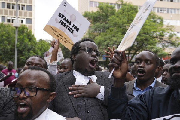 Human rights activists and members of the Law Society of Kenya hold a peaceful protest in which hundreds took part in Nairobi, Kenya Friday, Jan. 12, 2024. In recent weeks, Kenyan President William Ruto has threatened to disobey court orders, alleging that some judges are working with opposition politicians to block his administration's projects. (AP Photo/Brian Inganga)