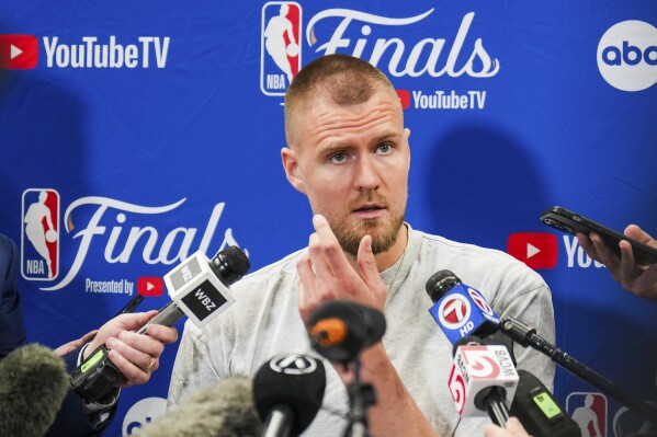 Boston Celtics center Kristaps Porzingis talks with reporters before basketball practice, Tuesday, June 11, 2024, in Dallas, in preparation for Game 3 of the NBA Finals against the Dallas Mavericks. (Smiley N. Pool/The Dallas Morning News via AP)