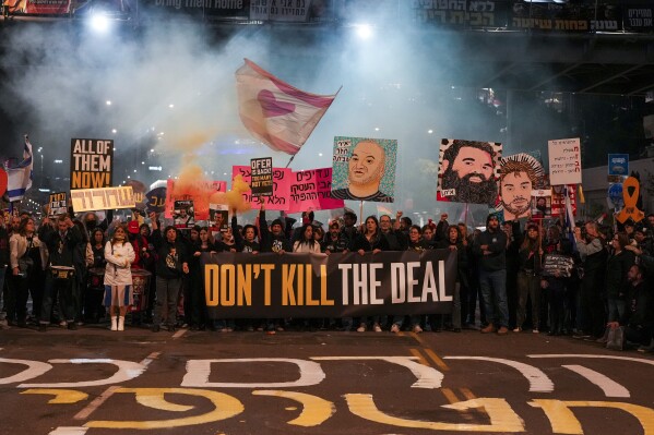 Protesters demanding the immediate release of hostages held by Hamas in the Gaza Strip, in Tel Aviv, Israel, Saturday, Feb. 15, 2025. (AP Photo/Ohad Zwigenberg)