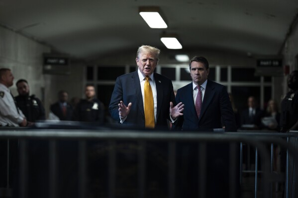 Former President Donald Trump speak to reporters, with his attorney, Todd Blanche, right, as jurors begin deliberations for his trial at the Manhattan criminal court, Wednesday, May 29, 2024, in New York. (Jabin Botsford/The Washington Post via AP, Pool)