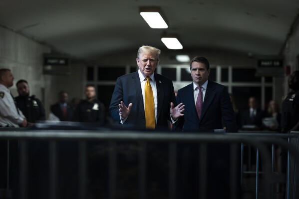 Former President Donald Trump speaks to reporters with his lawyer Todd Blanche, right, as jurors begin deliberations in the trial of former President Trump at Manhattan Criminal Court in New York, Wednesday, May 29, 2024. (Jabin Botsford/The Washington Post via Associated Press, Pool)