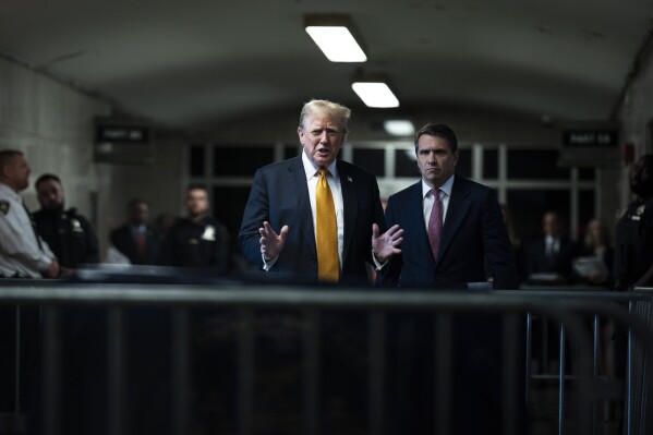 Former President Donald Trump speaks to reporters, with his attorney, Todd Blanche, right, as jurors begin deliberations for his trial in Manhattan Criminal Court, Wednesday, May 29, 2024, in New York.  (Jabin Botsford/The Washington Post via AP, Pool)