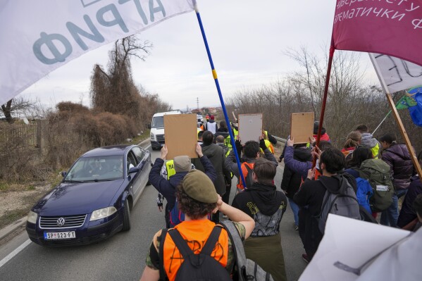 Students march trough the fields near the village of Cumic near the Serbian industrial town of Kragujevac, to protest the deaths of 15 people killed in the November collapse of a train station canopy, Friday, Feb. 14, 2025. (AP Photo/Darko Vojinovic)