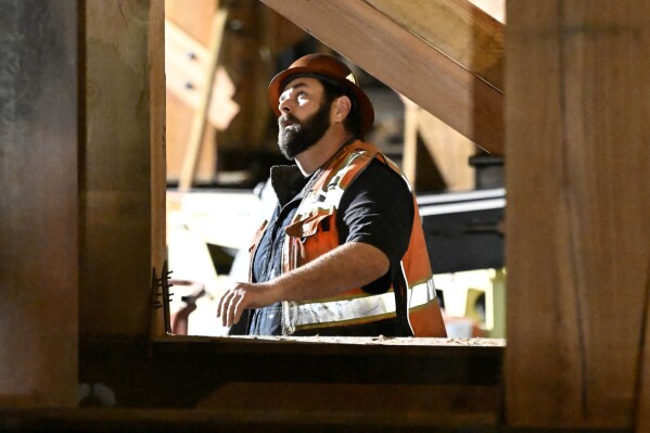 FILE - A construction worker looks up at the I-10 freeway, which was closed by fire on Nov. 19, 2023, in Los Angeles. On Friday, March 8, 2024, the U.S. government issues its February jobs report. (AP Photo/Alex Gallardo, File)