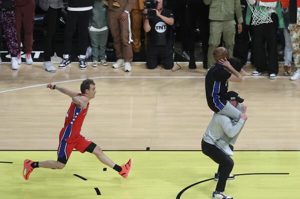 Mac McClung of the Philadelphia 76ers shoots during the slam dunk competition of the NBA basketball All-Star weekend Saturday, Feb. 18, 2023, in Salt Lake City. (AP Photo/Rob Gray)
