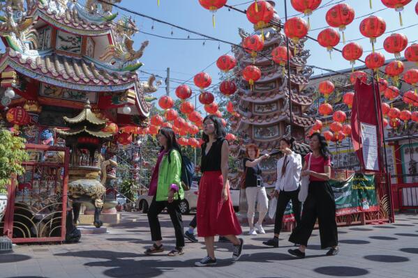 Chinese tourists tour Pung Tao Gong Chinese Temple in Chiang Mai province, northern Thailand, Monday, Jan. 23, 2023. The beaches and temples of destinations like Bali and Chiang Mai are the busiest they have been since the pandemic struck three years ago, but they’re still relatively quiet. (AP Photo/Wichai Thaprieo)