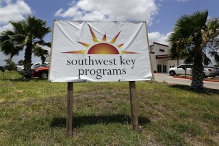 FILE- This June 20, 2014 file photo shows the Southwest Key-Nueva Esperanza, in Brownsville, Texas, a facility that shelters unaccompanied immigrant children. A national provider of shelters for immigrant children will reopen one of two Arizona facilities it was forced to shutter last year because of issues with employee background checks. The Arizona Department of Health Services said Wednesday, Sept. 4, 2019, it approved an application by Southwest Key to reopen a Phoenix facility that can house 420 children. The shelters are for kids who traveled to the U.S. alone or were separated from a relative. (AP Photo/Eric Gay, File)