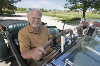 This 2007 image released by G.P. Putnam's Sons shows author Clive Cussler riding in a classic car. Cussler died on Monday, Feb. 24, 2020 at his home in Scottsdale, AZ. He was 88. (Ronnie Bramhall/G.P. Putnam's Sons via AP)