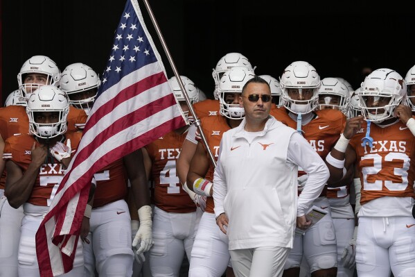 Texas head coach Steve Sarkisian and his team prepare to take the field for an NCAA college football game against BYU in Austin, Texas, Saturday, Oct. 28, 2023. (AP Photo/Eric Gay)