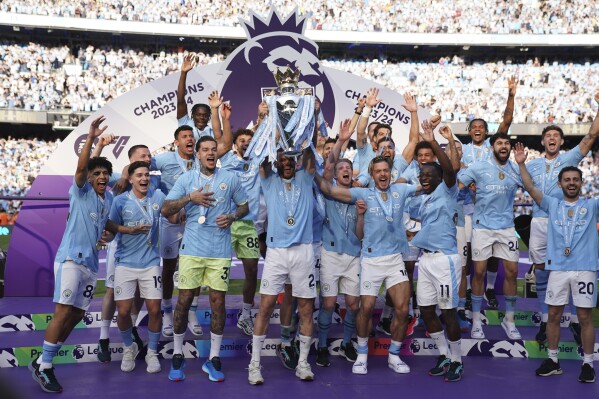 Los jugadores del Manchester City alzan el trofeo de campeones de la Liga Premier, el domingo 19 de mayo de 2024, en el estadio Etihad. (AP Foto/Dave Thompson)
