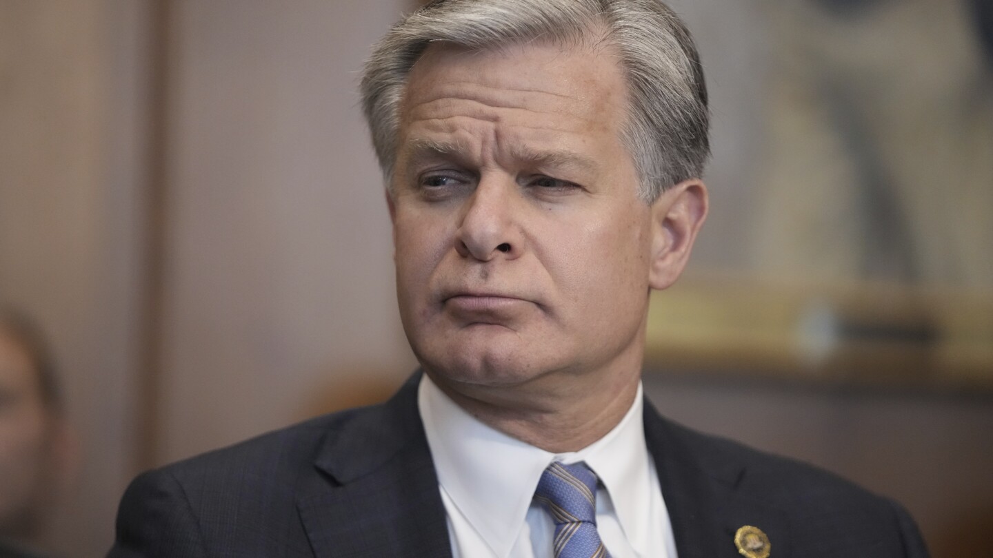 FBI Director Christopher Wray listens during a meeting of the Justice Department’s Election Threats Task Force at the Department of Justice, Wednesd