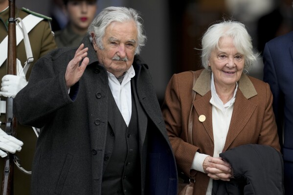 FILE - Uruguay's former President Jose Mujica, left, and his wife Lucia Topolansky enter La Moneda presidential palace for a ceremony marking the 50th anniversary of the military coup that toppled the government of late President Salvador Allende in Santiago, Chile, Sept. 11, 2023. Mujica announced on April 29, 2024, that he has esophageal cancer after a tumor was detected during a medical check-up. (AP Photo/Esteban Felix, File)
