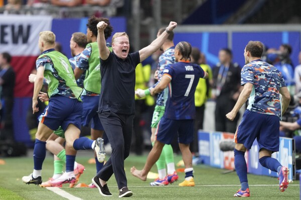 Netherlands' head coach Ronald Koeman celebrates after Wout Weghorst of the Netherlands scored during the Group D match between Poland and the Netherlands at the Euro 2024 soccer tournament in Hamburg, Germany, Sunday, June 16, 2024. (AP Photo/Ebrahim Noroozi)