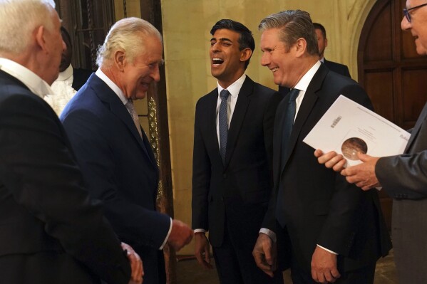 FILE - Britain's King Charles III speaks with Britain's Prime Minister Rishi Sunak, center, and Labour leader Keir Starmer, second right, as Speaker of the House of Commons, Sir Lindsay Hoyle, left, looks on during his visit to Westminster Hall at the Palace of Westminster to attend a reception ahead of the coronation, in London, on May 2, 2023. (Arthur Edwards/Pool Photo via AP, File)