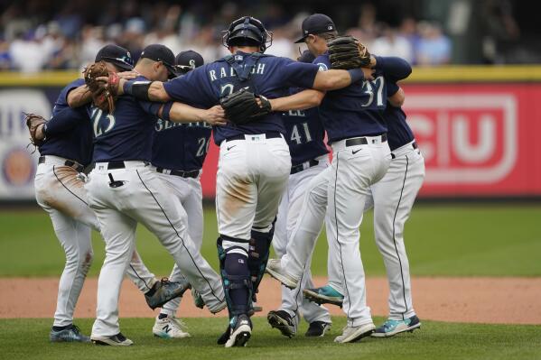 Seattle Mariners players dance as they celebrate their 4-3 win over the New York Yankees in a baseball game, Wednesday, Aug. 10, 2022, in Seattle. (AP Photo/Ted S. Warren)