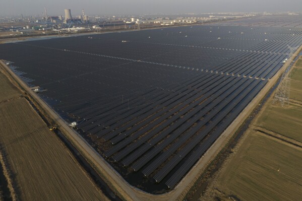 A solar farm stretches out near a chemical plant in the outskirts of Weifang in eastern China's Shandong province on March 22, 2024. It's the leading province for renewable energy capacity, but that also means it's the first to encounter the difficulties of rapid growth. (AP Photo/Ng Han Guan)