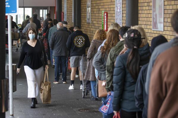Shoppers lineup to enter a supermarket in Auckland, New Zealand, Tuesday, Aug. 17, 2021. New Zealand's government took drastic action Tuesday by putting the entire nation into a strict lockdown after detecting just a single community case of the coronavirus. (Brett Phibbs/New Zealand Herald via AP)