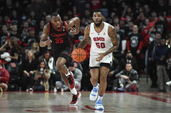 SMU forward Marcus Weathers (50) brings the ball up court against Houston forward Fabian White Jr. (35) during the first half of an NCAA college basketball game Sunday, Feb. 27, 2022, in Houston. (AP Photo/Justin Rex)