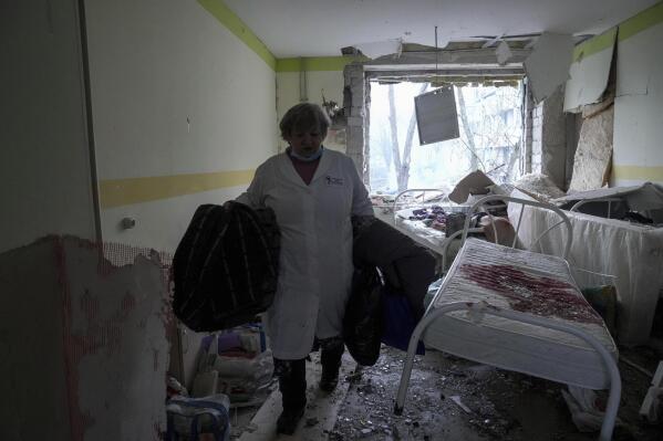 FILE - A medical worker walks through the damaged maternity hospital in Mariupol, Ukraine, Wednesday, March 9, 2022. A Russian attack has severely damaged the hospital in the besieged port city of Mariupol, Ukrainian officials say. (AP Photo/Evgeniy Maloletka, File)