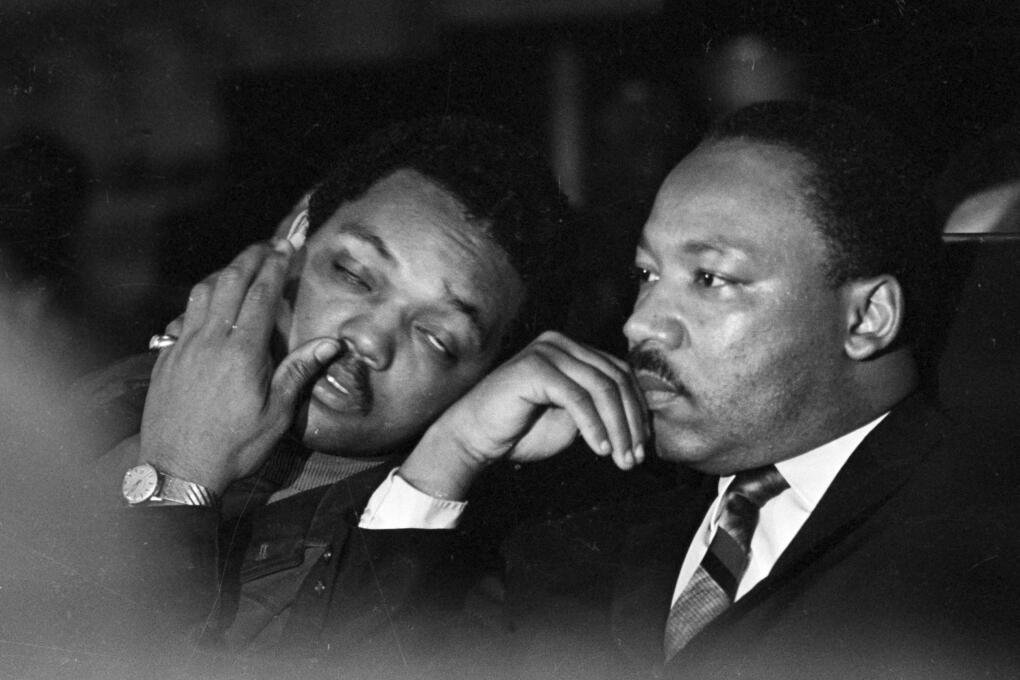 Dr. Martin Luther King, Jr. is seen here with Rev. Jesse Jackson, left, just prior to his final public appearance to address striking Memphis sanitation workers on April 4, 1968.  King was assassinated later that day outside his motel room.  (AP Photo/Charles Kelly)