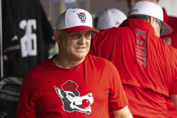 North Carolina State head coach Elliott Avent talks with others in the dugout during a COVID-19 protocol delay before playing against Vanderbilt during a baseball game in the College World Series, Friday, June 25, 2021, at TD Ameritrade Park in Omaha, Neb. (AP Photo/Rebecca S. Gratz)