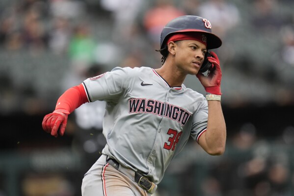 Washington Nationals' Trey Lipscomb runs the bases after hitting a single, allowing Nick Senzel to score, during the eighth inning in the first baseball game of a doubleheader against the Chicago White Sox, Tuesday, May 14, 2024, in Chicago. (AP Photo/Erin Hooley)