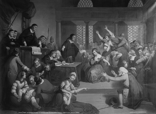 This image provided by the Library of Congress shows the painting "Trial of George Jacobs of Salem for Witchcraft" in 1692 signed "T.H. Matteson, 1855." From the Salem witch trials to fears of the Illuminati to the Red Scare to QAnon, conspiracy theories have always served as dark counter programming to the American story taught in history books. (Tompkins Harrison Matteson/Library of Congress via AP)
