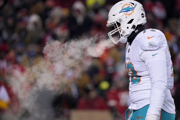 FILE - Miami Dolphins guard Austin Jackson walks on the field during the first half of the team's NFL wild-card playoff football game against the Kansas City Chiefs on Jan. 13, 2024, in Kansas City, Mo. While the U.S. is shivering through bone-chilling cold, most of the rest of world is feeling unusually warm weather. Scientists Tuesday, Jan. 16, say that fits with what climate change is doing to Earth. (AP Photo/Ed Zurga, File)