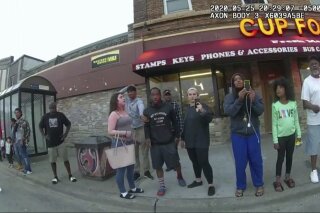 FILE - This May 25, 2020, file image from a police body camera shows bystanders including Alyssa Funari, left filming, Charles McMillan, center left in light colored shorts, Christopher Martin center in gray, Donald Williams, center in black, Genevieve Hansen, fourth from right filming, Darnella Frazier, third from right filming, as former Minneapolis police officer Derek Chauvin was recorded pressing his knee on George Floyd's neck for several minutes in Minneapolis. To the prosecution, the witnesses who watched Floyd's body go still were regular people -- a firefighter, a mixed martial arts fighter, a high school student and her 9-year-old cousin in a T-shirt emblazoned with the word "Love." (Minneapolis Police Department via AP, File)