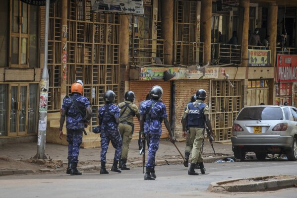 Ugandan security forces patrol on a street in Kampala, Uganda Thursday, Nov. 19, 2020. The death toll from protests over the latest arrest of Ugandan opposition presidential hopeful and musician Bobi Wine has risen to 16, police said Thursday, as a second day of demonstrations continued in the country's worst unrest in a decade. (AP Photo)