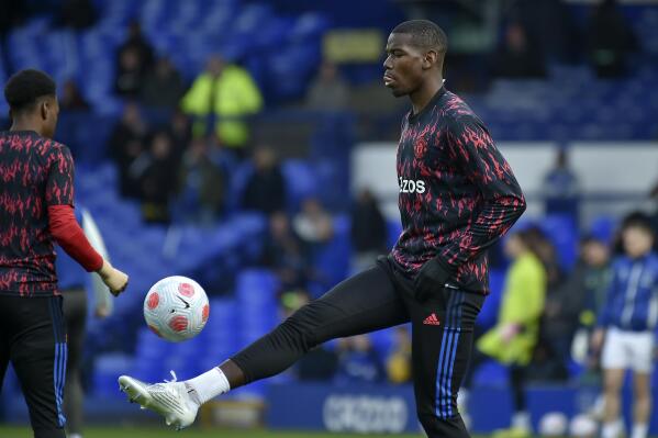 FILE - Manchester United's Paul Pogba plays with a ball during warmup before the Premier League soccer match between Everton and Manchester United at Goodison Park, in Liverpool, England, April 9, 2022. Pogba joined Manchester United for a world-record fee and will leave the English club for nothing. United says the France midfielder will be departing Old Trafford at the end of the month when his contract expires. (AP Photo/Rui Vieira, File)