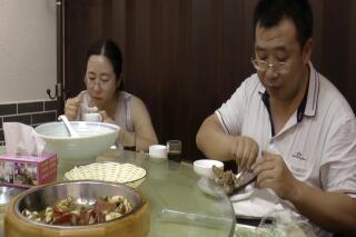 This image made from  Aug. 1, 2016 video shows Chen Guiqiu, left, has lunch with lawyer Jiang Tianyong after attending a trial for human rights lawyer and activists at the Tianjin No. 2 Intermediate People's Court in Tianjin, China. Chen, the wife of human rights lawyer Xie Yang held in China for inciting subversion, tells The Associated Press of how she and her two daughters fled the country to Thailand, where they were nearly deported back to China before the US stepped in. (AP Photo)