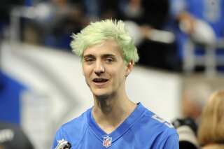 FILE - In this Sept. 10, 2018, file photo, Fortnite superstar Tyler "Ninja" Blevins watches before an NFL football game between the Detroit Lions and New York Jets in Detroit. Blevins is leaving Tw...