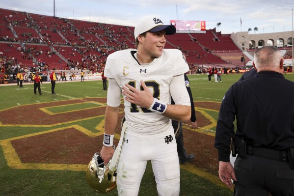 Notre Dame quarterback Riley Leonard reacts after the team's win against Southern California in an NCAA college football game Saturday, Nov. 30, 2024, in Los Angeles. (AP Photo/Ryan Sun)