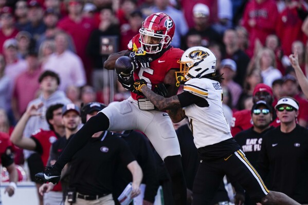 Georgia wide receiver Rara Thomas (5) makes a catch as Missouri defensive back Kris Abrams-Draine (7) defends during the first half of an NCAA college football game, Saturday, Nov. 4, 2023, in Athens, Ga. (AP Photo/John Bazemore)