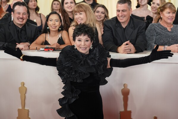 FILE - Rita Moreno arrives at the Oscars on Sunday, March 10, 2024, at the Dolby Theatre in Los Angeles. Moreno will be honored for her career and philanthropic accomplishments at the WNET Group 2024 Gala at the Edison Ballroom in New York City on Tuesday, May 7, 2024. (AP Photo/John Locher, File)