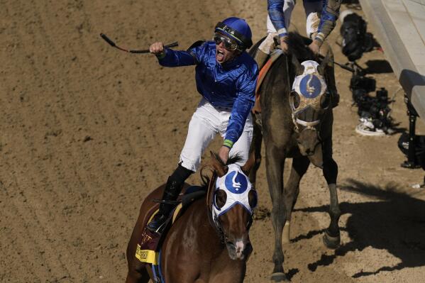 Tyler Gaffalione riding Pretty Mischievous celebrates after winning the 149th running of the Kentucky Oaks horse race at Churchill Downs Friday, May 5, 2023, in Louisville, Ky. (AP Photo/Charlie Riedel)