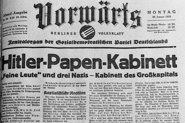 Image shows the front page of the German national newspaper "Vorw盲rts" (Ahead) from Monday, January 30, 1933, reporting on the formation of the new German Cabinet with Hitler as Chancellor and von Hindenburg as president, with a photo of Nazis and citizens at the Lustgarten yesterday in Berlin January 29, 1933. (APPhoto)