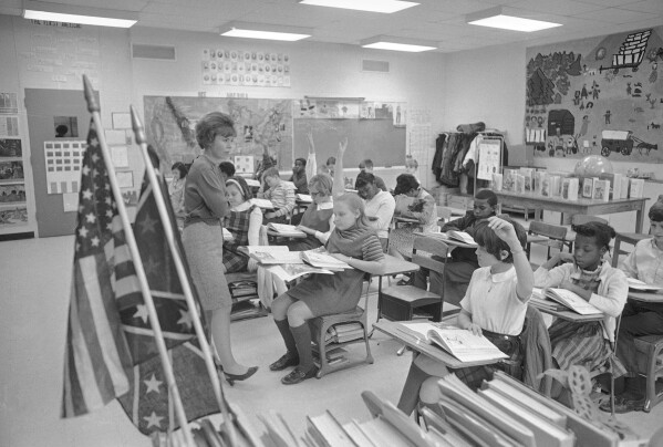 FILE - Fifth graders of the West Greene Elementary School in Snow Hill, N.C., study history in an integrated classroom with teacher Charlaron May, March 5, 1969. The school is the first in the eastern Carolina community to be fully integrated. Friday, May 17, 2024, marks 70 years since the U.S. Supreme Court ruled that separating children in schools by race was unconstitutional. On paper, Brown v. Board of Education still stands. In reality, school integration is all but gone, the victim of a gradual series of court cases that slowly eroded it, leaving little behind. (AP Photo/Perry Aycock, File)
