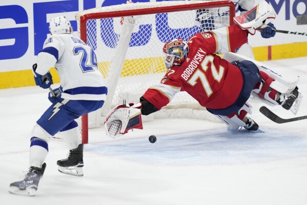 Florida Panthers goaltender Sergei Bobrovsky (72) blocks a shot by Tampa Bay Lightning defenseman Matt Dumba (24) during the second period of Game 2 of the first-round of an NHL Stanley Cup Playoff series, Tuesday, April 23, 2024, in Sunrise, Fla. (AP Photo/Wilfredo Lee)