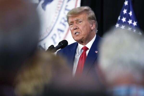 FILE - Former President Donald Trump visits with campaign volunteers at the Elks Lodge, July 18, 2023, in Cedar Rapids, Iowa. (AP Photo/Charlie Neibergall, File)