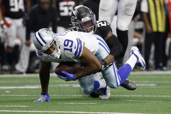 Dallas Cowboys wide receiver Amari Cooper (19) catches a pass for a first down before being tackled by Atlanta Falcons safety Duron Harmon in the first half of an NFL football game in Arlington, Texas, Sunday, Nov. 14, 2021. (AP Photo/Ron Jenkins)