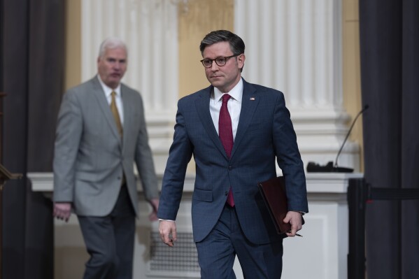 Speaker of the House Mike Johnson, R-La., right, arrives to meet with reporters at the Capitol in Washington, March 6, 2024. (AP Photo/J. Scott Applewhite, File)