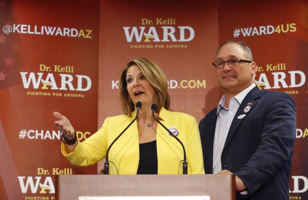 FILE - Kelli Ward, with her husband Mike at her side, concedes to Sen. John McCain, R-Ariz. in the race for the Republican nomination to U.S. Senate, at her primary night party at a hotel in Scottsdale, Ariz., on Aug. 30, 2016. A federal judge, late Thursday, Sept. 22, 2022, has rejected an effort by Ward and her husband to block a subpoena of their phone records issued by the House committee investigating the Jan. 6 insurrection at the U.S. Capitol. (David Kadlubowski/The Arizona Republic via AP, File)