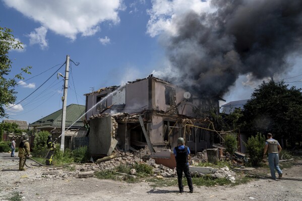 Ukrainian State Emergency Service firefighters put out a fire at a house destroyed in a Russian shelling, in a residential neighbourhood, in Kherson, Ukraine, Saturday, July 1, 2023. (AP Photo/Evgeniy Maloletka)