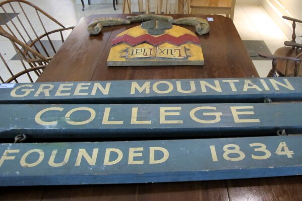 In this Friday, Sept. 20, 2019 photograph, a Green Mountain College sign is on display among the goods to be sold at an auction at the school in Poultney, Vt. The school closed in May and now the town that hosted it for 185 years is awaiting to hear what will become of the campus. (AP Photo/Lisa Rathke)